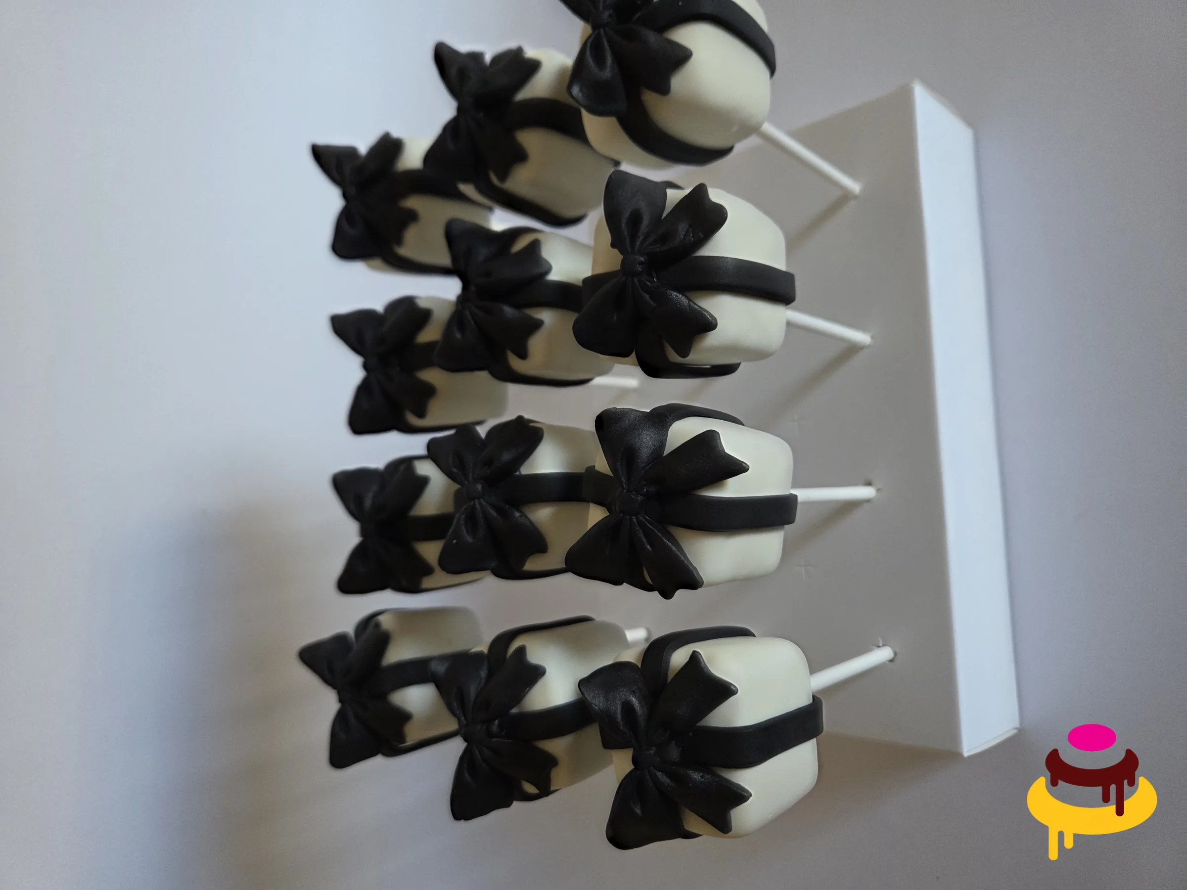 Black bow tuxedo cake pops for an elegant party in the Bay Area