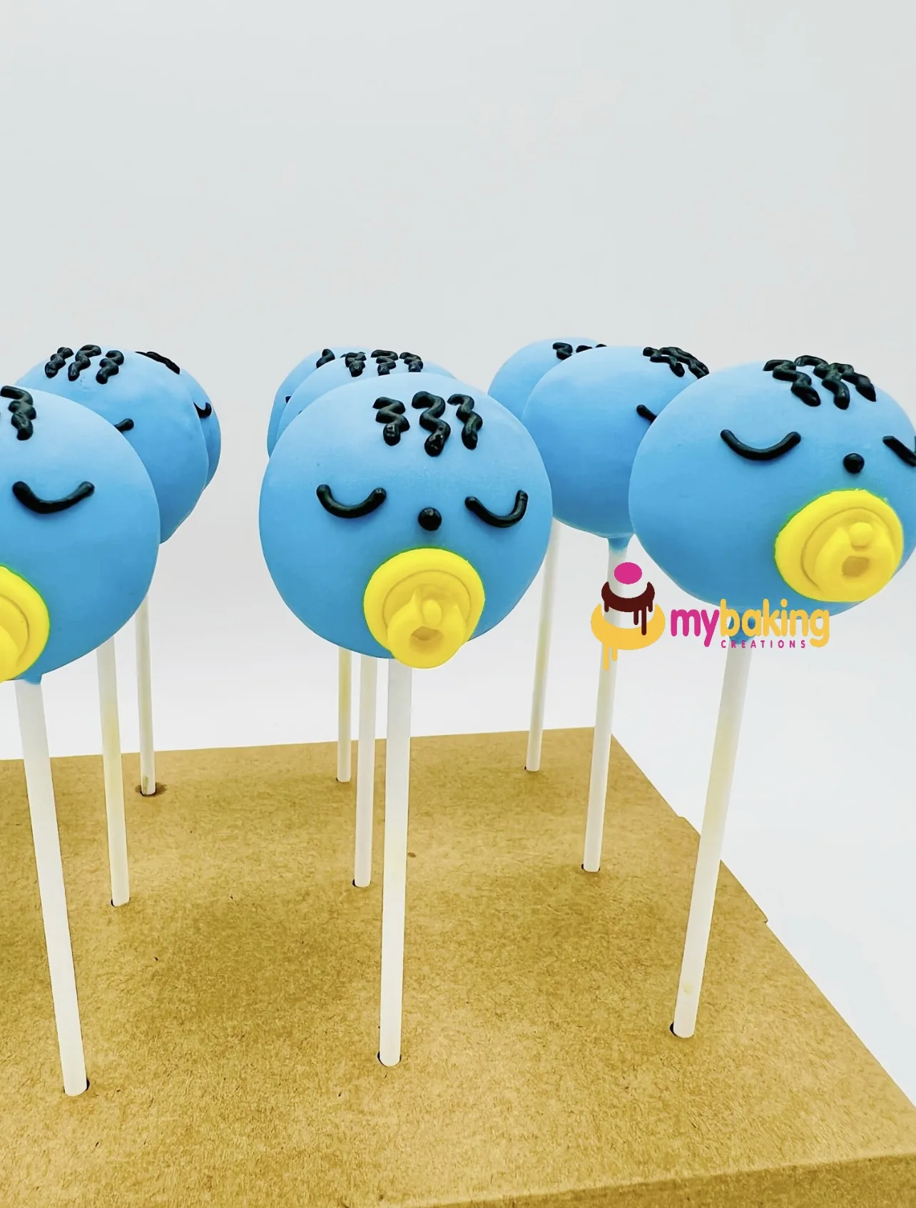 Blue bird cake pops with pacifiers for a baby shower in the Bay Area