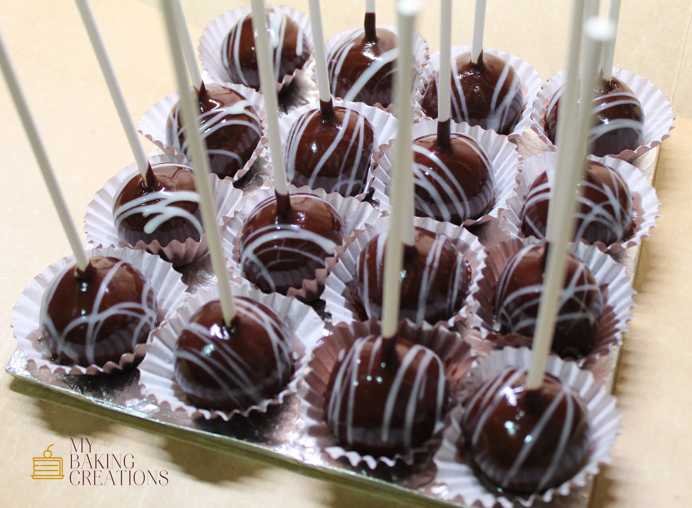 Chocolate dipped cake pops with white drizzle in the San Francisco Bay Area