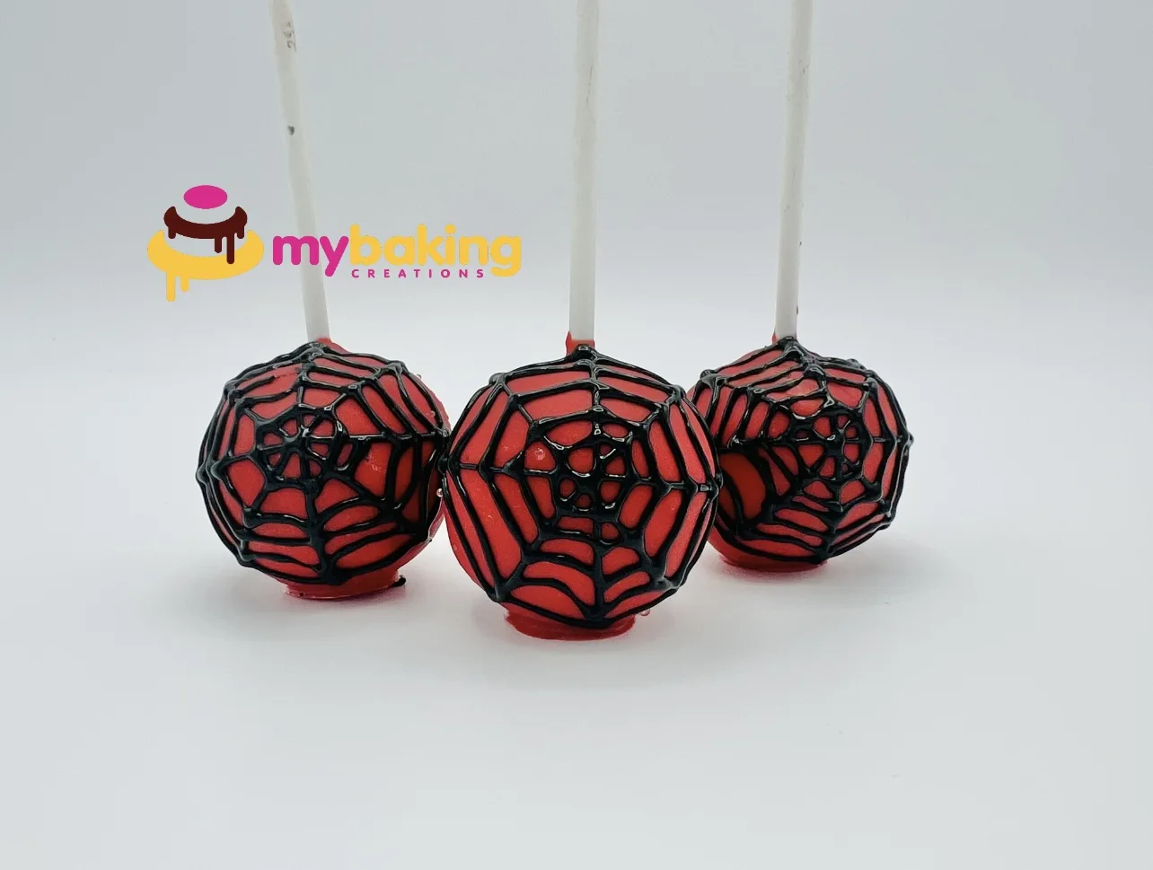 Halloween spider web cake pops in orange and black for San Francisco parties