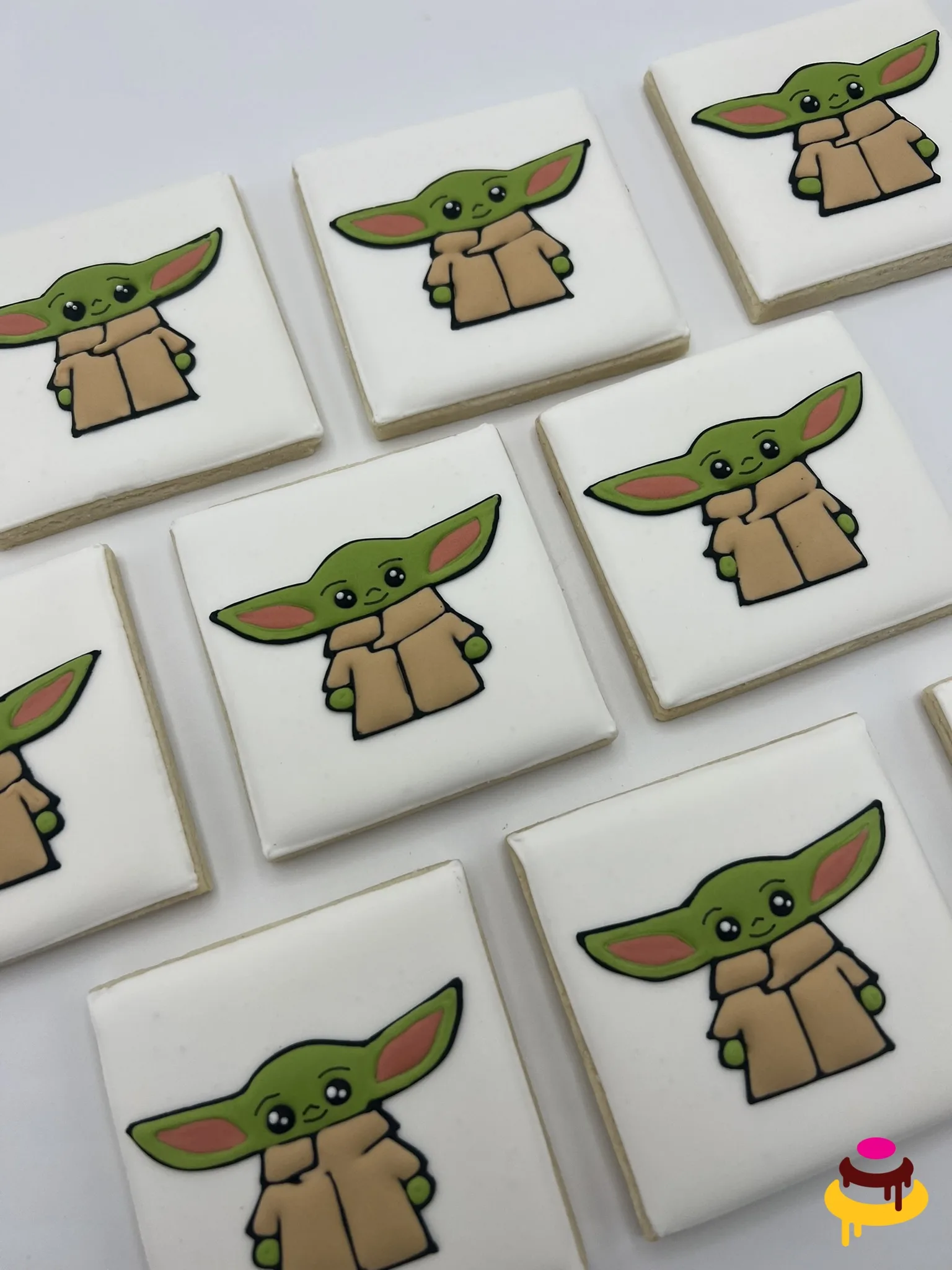 Printed image cookies with a Baby Yoda design on white royal icing